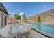 Backyard pool and patio area featuring comfortable seating for outdoor dining and relaxation at 2124 Pont National Dr, Henderson, NV 89044