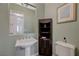 Charming powder room with pedestal sink, decorative mirror, and neutral color scheme at 2124 Pont National Dr, Henderson, NV 89044