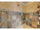 Modern bathroom with tiled shower, built-in bench, and stone accents at 2124 Pont National Dr, Henderson, NV 89044