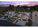 Panoramic aerial view of a neighborhood showcasing a home with solar panels, a pool, and a putting green at 219 Windsong Dr, Henderson, NV 89074