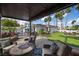 Inviting backyard features a pool, patio, bar, and lush artificial grass lawn at 219 Windsong Dr, Henderson, NV 89074