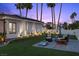 Secluded backyard featuring a manicured lawn, comfortable seating area, and decorative Philadelphia cornhole game at 219 Windsong Dr, Henderson, NV 89074