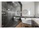 This bathroom features a glass shower and a soaking tub next to dark cabinetry with a granite countertop at 219 Windsong Dr, Henderson, NV 89074
