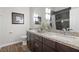 Stylish bathroom showcasing double sinks, granite countertops, and modern lighting fixtures at 219 Windsong Dr, Henderson, NV 89074