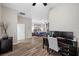A bedroom with ensuite features hardwood floors, neutral walls, modern decor, and ceiling fan at 219 Windsong Dr, Henderson, NV 89074