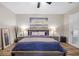 A staged bedroom offers hardwood floors, neutral walls, modern decor, and plantation shutters at 219 Windsong Dr, Henderson, NV 89074