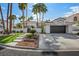 Inviting desert home featuring a well-maintained lawn and a three car garage at 219 Windsong Dr, Henderson, NV 89074