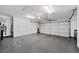 Spacious garage with epoxy floors, white cabinets and an automatic garage door at 219 Windsong Dr, Henderson, NV 89074
