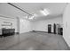 Large garage featuring epoxy floors, white cabinets and overhead lighting at 219 Windsong Dr, Henderson, NV 89074
