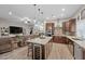 Open-concept kitchen features an island with seating and wine storage, flowing into the living room at 219 Windsong Dr, Henderson, NV 89074