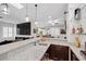 This modern kitchen features granite countertops and stainless steel sink with a bar overlooking the living space at 219 Windsong Dr, Henderson, NV 89074