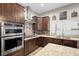 Modern kitchen featuring stainless steel appliances, stylish backsplash, and granite countertops at 219 Windsong Dr, Henderson, NV 89074
