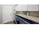 Efficient laundry room featuring a granite countertop, modern washer/dryer, and storage cabinets at 219 Windsong Dr, Henderson, NV 89074