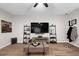Simple living room with TV and wood-look flooring at 219 Windsong Dr, Henderson, NV 89074