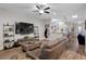 Comfortable living room featuring a large flat-screen TV and wood-look floors at 219 Windsong Dr, Henderson, NV 89074