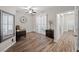 An office features hardwood floors, neutral walls, modern decor, ceiling fan, and plantation shutters at 219 Windsong Dr, Henderson, NV 89074