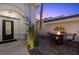 Charming outdoor patio with wrought-iron seating area and a cozy fire pit, perfect for entertaining at 219 Windsong Dr, Henderson, NV 89074