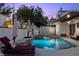 Beautiful pool area with a spa, lounge chairs, and outdoor umbrellas for shade at 219 Windsong Dr, Henderson, NV 89074