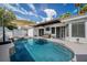 Inviting backyard pool and spa offers a relaxing oasis, along with an awning, and seating area for outdoor enjoyment at 219 Windsong Dr, Henderson, NV 89074