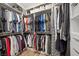 Spacious walk-in closet with custom shelving and hanging racks for optimal clothing storage at 219 Windsong Dr, Henderson, NV 89074