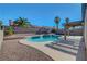 This beautiful backyard features a refreshing blue pool, palm trees and privacy at 2711 Briarcliff Ave, Henderson, NV 89074