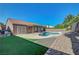 Inviting backyard showcasing a pool, a partially covered patio, and well-maintained landscaping at 2711 Briarcliff Ave, Henderson, NV 89074