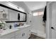 This bathroom features a double sink, large mirror and glass enclosed shower at 2711 Briarcliff Ave, Henderson, NV 89074