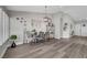 Open dining room features hardwood floors, modern lighting and decor with access to other rooms at 2711 Briarcliff Ave, Henderson, NV 89074