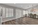 Open dining room features hardwood floors, modern lighting and decor with view of the backyard pool at 2711 Briarcliff Ave, Henderson, NV 89074