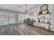 Open dining room features hardwood floors, modern lighting and decor with view of the backyard pool at 2711 Briarcliff Ave, Henderson, NV 89074