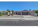 Welcoming front exterior showcasing a desert landscaped yard, tile roof, and a two-car garage at 2711 Briarcliff Ave, Henderson, NV 89074
