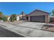 Inviting exterior view featuring a two-car garage, desert landscaping, and a classic design at 2711 Briarcliff Ave, Henderson, NV 89074