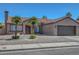 Attractive front exterior with a tile roof, desert landscaping, and a two-car garage at 2711 Briarcliff Ave, Henderson, NV 89074