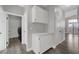 Hallway with built-in cabinetry near a laundry room featuring modern appliances at 2711 Briarcliff Ave, Henderson, NV 89074