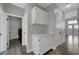 Hallway with built-in cabinetry near a laundry room featuring modern appliances at 2711 Briarcliff Ave, Henderson, NV 89074