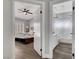 View of a bedroom with ceiling fan and bathroom featuring modern fixtures and a shower-tub combo at 2711 Briarcliff Ave, Henderson, NV 89074