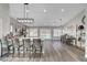 Spacious open concept kitchen with bar seating island, dining space, and modern lighting fixtures at 2711 Briarcliff Ave, Henderson, NV 89074