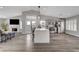 Open-concept kitchen with a large center island, stainless steel appliances, and hardwood floors at 2711 Briarcliff Ave, Henderson, NV 89074
