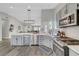 Modern kitchen boasts a large island, stainless steel appliances and an open living space at 2711 Briarcliff Ave, Henderson, NV 89074