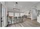 Open kitchen with bar seating, modern light fixtures, and stainless steel appliances at 2711 Briarcliff Ave, Henderson, NV 89074
