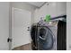 Modern laundry room featuring front load washer and dryer appliances at 2711 Briarcliff Ave, Henderson, NV 89074