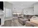 Spacious living room featuring a gray sectional, fireplace, and open-concept design at 2711 Briarcliff Ave, Henderson, NV 89074