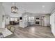 Open living space features a modern kitchen, dining area, and living room with hardwood floors at 2711 Briarcliff Ave, Henderson, NV 89074
