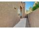 This single-Gathering home has a simple desert landscape, window accents, and a high privacy wall at 2711 Briarcliff Ave, Henderson, NV 89074