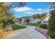 Manicured backyard featuring an artificial lawn, stone landscaping and pergola covered patio at 2873 Knoxville Ct, Henderson, NV 89052