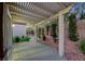 Covered patio in backyard with concrete pavers, pergola, and privacy landscaping at 2873 Knoxville Ct, Henderson, NV 89052