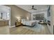 Stylishly furnished bedroom with wood floors, a ceiling fan, and a seating area at 2873 Knoxville Ct, Henderson, NV 89052
