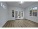 Bright and spacious bedroom featuring wood floors and double doors leading to the backyard at 2873 Knoxville Ct, Henderson, NV 89052