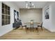 Dining area with a round wooden table, modern light fixture, and ample natural light at 2873 Knoxville Ct, Henderson, NV 89052