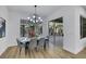Light and airy dining area featuring modern light fixture and sliding glass door to the outside at 2873 Knoxville Ct, Henderson, NV 89052